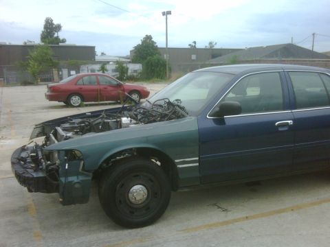 2005 Ford Crown Victoria - This 2005 Ford Crown Victoria has its hood open, revealing the engine compartment and wiring.