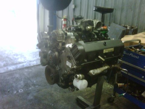 2005 Ford Crown Victoria - An engine is mounted on an engine stand in what appears to be a workshop or garage.