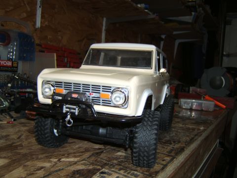 1988 Ford Bronco - A detailed RC car model resembling a vintage SUV sits on a workbench.