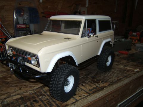 1988 Ford Bronco - RC crawler resembling a 1970s Ford Bronco sits on a workbench.