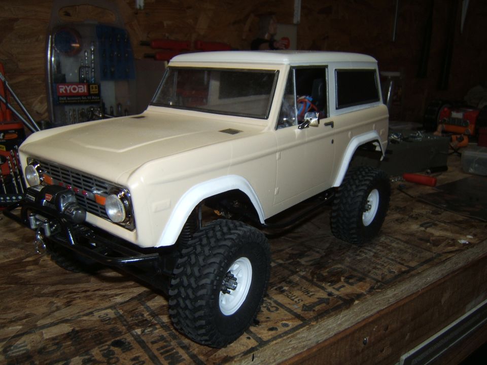 Tan RC crawler with white roof and fender flares, front winch