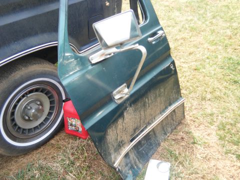 1981 Ford E350 - The door and wheel of a 1981 Ford E350 van are visible in this image.