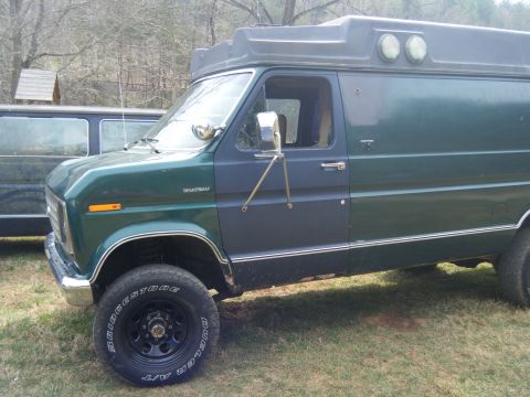 1981 Ford E350 - Ford E-Series van, possibly a 1975 model, modified with a camper top.