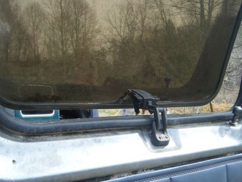 1981 Ford E350 - Vent window open, reflecting trees and sky. The Supermotors.net logo is visible at the bottom right.