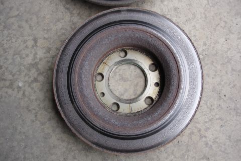 2006 Ford Fusion - A single brake rotor is shown, exhibiting signs of rust and wear on its surface.