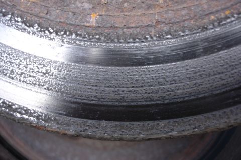 2006 Ford Fusion - This brake rotor shows significant wear and pitting, indicating it needs replacement.
