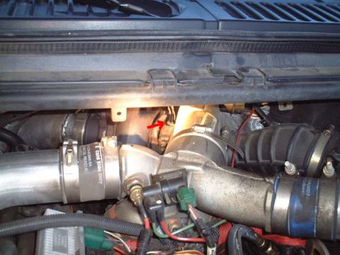 2000 Ford Excursion - Engine bay view of turbocharger plumbing with a red arrow indicating a sensor.