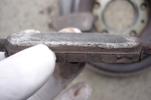 2006 Ford Fusion - Close-up of a worn brake pad, indicating need for replacement.