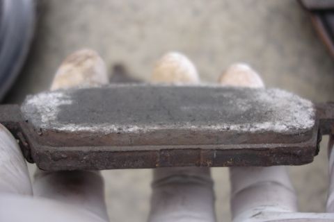 2006 Ford Fusion - Worn brake pad showing dust and residue, likely needing replacement.