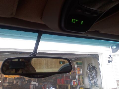1977 Ford F-100 - The vehicle's interior features a digital temperature display and a compass integrated into the rearview mirror.