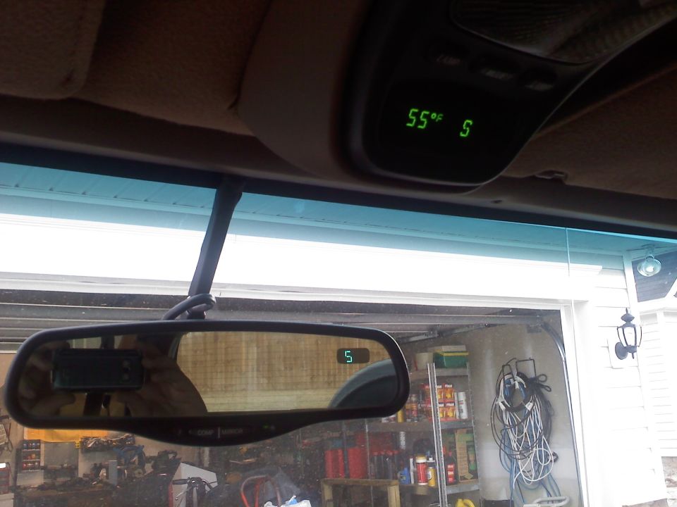 Interior shot showing a digital display on the overhead console reading 55 degrees Fahrenheit and a digital compass in the rearview mirror showing 'S'