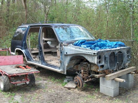 1990 Ford Explorer - This 1990 Ford Explorer is missing its front end and is supported by concrete blocks.