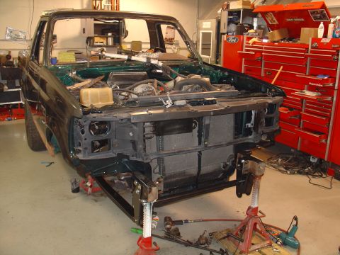 1995 Ford Bronco - Front end of a 1995 Ford Bronco disassembled for repair or restoration in a workshop.