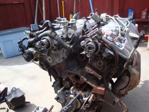 1989 Ford Taurus - Engine block assembly with various components and wiring, likely removed for repair or rebuilding.