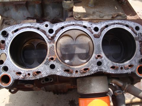 1989 Ford Taurus - This engine block shows significant wear and corrosion around the cylinder bores and gasket mating surfaces.
