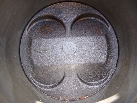 1989 Ford Taurus - Close-up of a piston top within a cylinder bore, showing valve reliefs and cylinder designation.