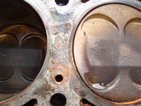 1989 Ford Taurus - Close-up view of engine pistons within a corroded block, indicating significant wear and tear.