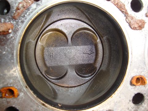1989 Ford Taurus - Close-up of an engine cylinder with a piston, showing intake and exhaust valve seats.