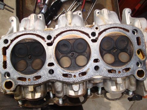 1989 Ford Taurus - Close-up of an engine cylinder head, revealing internal components and signs of use.