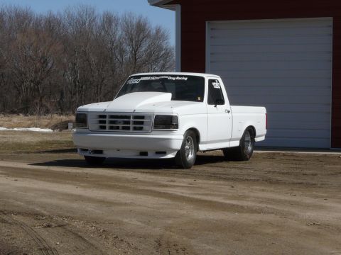 1994 Ford F-150 - Lowed it a little more with some suspension adjustments, 4 link suspension, and bigger wheel tubs. Also a bigger slick in the rear.