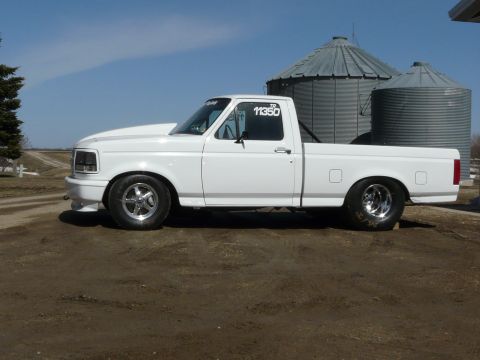 1994 Ford F-150 - Side view of a white 1994 Ford F-150 pickup truck modified for drag racing.