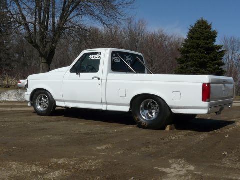 1994 Ford F-150 - This modified Ford F-150 pickup truck is equipped with drag racing tires and a roll bar.