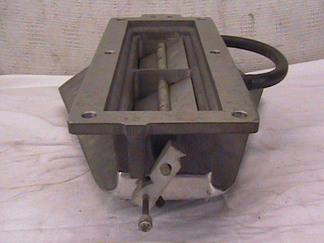 Aluminum intake manifold with a black hose loop and visible linkage