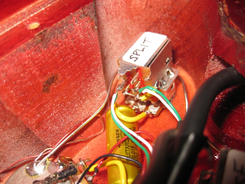 Guitar wiring with a toggle switch labeled 'SPLIT' and a yellow capacitor