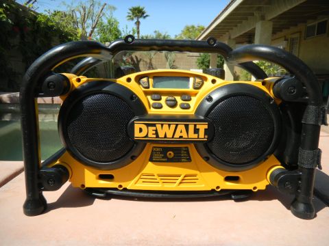1997 Ford Ranger - A yellow DeWalt radio sits on a surface outdoors, with a pool and house in the background.