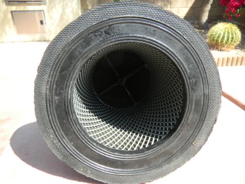 1997 Ford Ranger - End-on view down the open bore of a large cylindrical air filter element, showing the black rubber sealing end cap, the outer expanded-meta…