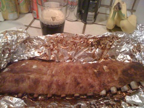 1989 Ford Bronco - A rack of ribs, cooked and wrapped in foil, sits on a counter next to a glass of Guinness and some bananas.