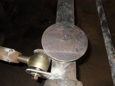 1997 Ford Ranger - Metal disc with crosshair marking being welded onto a pipe, part of a mechanical assembly.