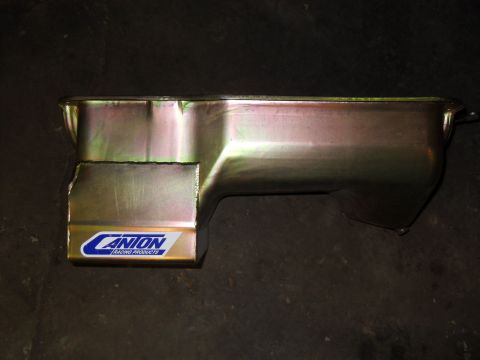1997 Ford Ranger - A Canton Racing Products oil pan is shown from the side against a dark background.