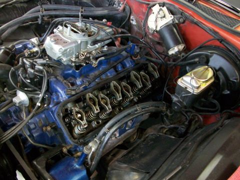 1973 Ford Ranchero - Close-up view of a vehicle's engine bay, showing internal engine components and the brake master cylinder.