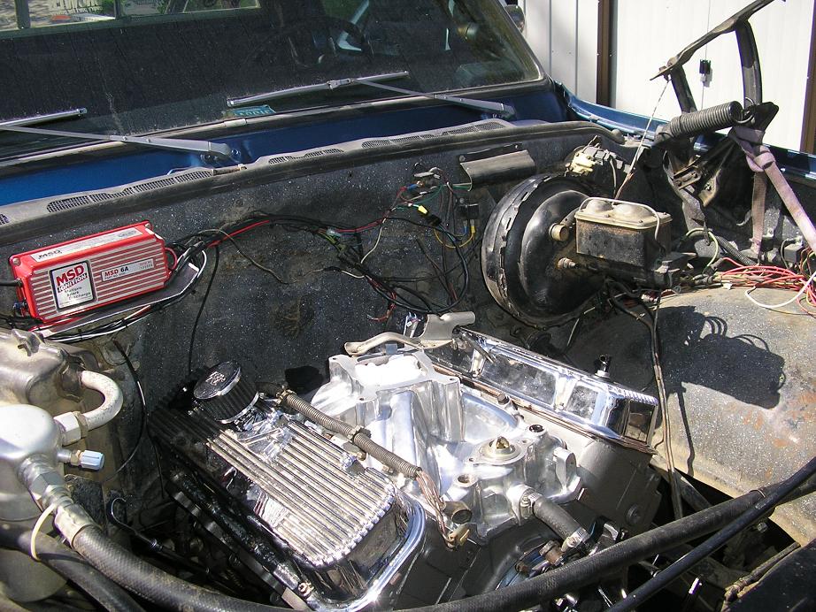 Engine bay showing a V8 engine with chrome valve covers, MSD ignition box, and brake booster