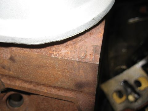 1994 Ford Bronco - A close-up view of a heavily rusted engine block shows some faint cast-in markings.