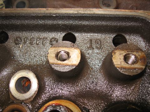 1994 Ford Bronco - This close-up shows cast markings and threaded bolt holes on an engine's cylinder head.