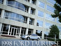 1998 Ford Taurus - 1998 Ford Taurus SE sedan parked in front of a large office building.