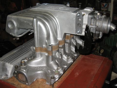1994 Ford Bronco - Close-up of a silver supercharger intake manifold assembly, likely for a performance engine.