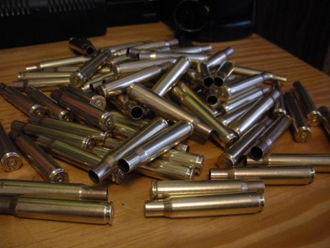 1996 Ford Bronco - A collection of used bullet casings rests on a table, suggesting recent firearm activity.