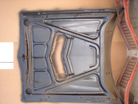 1973 Ford Ranchero - The reinforced underside of a car hood is visible, with its internal bracing structure.