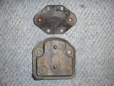 1979 Ford F-250 - Two metal automotive parts are shown against a carpeted background.