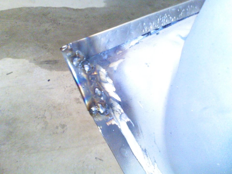 Welded metal panel with visible weld marks and a light blue surface