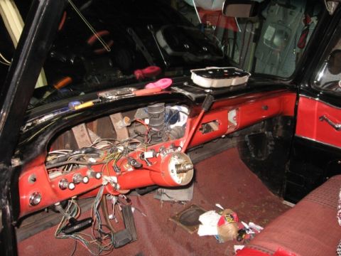 1966 Ford F-100 - The interior of a 1956 Ford F-100 shows a disassembled dashboard with wiring and tools scattered around.