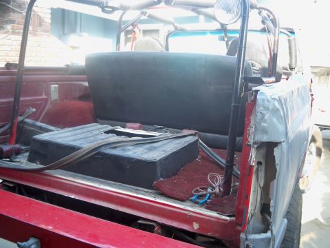 1985 Ford Bronco - Rear interior view of a 1985 Ford Bronco, a subwoofer box and exposed bodywork.