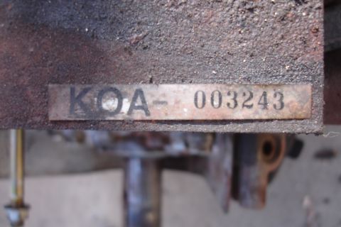 1993 Ford Taurus - A close-up view of a metal identification plate with the characters KOA-003243.