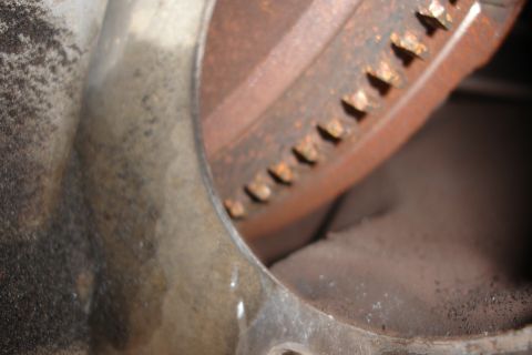 1993 Ford Taurus - A close-up view of a rusty, toothed metal component within an engine.