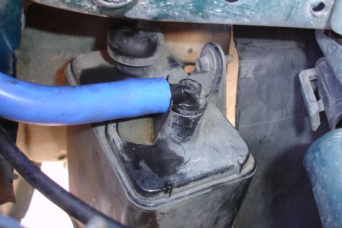 1995 Ford Taurus - Engine bay component with a blue hose connected to a nozzle.