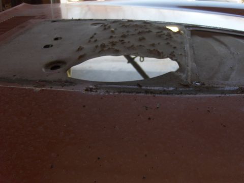 1980 Chevrolet Camaro - The rear window frame of this vehicle shows significant rust and damage.