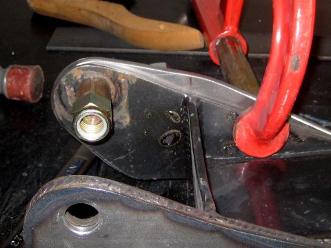 1996 Ford Bronco - Close-up of a metal automotive part, possibly a suspension component, secured with a clamp.